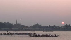 Longboats cruise past temples on the shore of the Mekong River in Cambodia Stock Footage