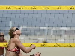 CU of female beach volleyball players spiking and blocking at the net. Stock Footage