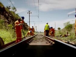 WS POV View of rail road workers standing outside of train tunnel / South Africa Stock Footage