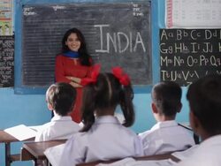 Teacher teaching her school students in a classroom   Stock Footage
