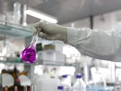 Scientist shake beaker of liquid Stock Footage