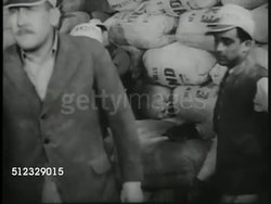 1937: DRAMATIZATION: WS EXT Brick building. INT Man sitting on flour sacks talking w/ other men. SOT Men in office w/ Mill owner saying he won't stand for it, he'll close mill, lead male saying they'll report him to Labor Relation Board. Labor Law. Instructional Video