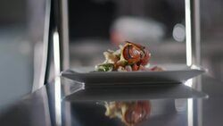 Chef places finished entr_es on counter for waiter pick-up in restaurant kitchen Stock Footage