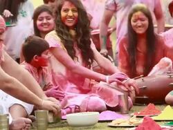 Family celebrating holi festival in the lawn  Stock Footage