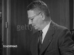 1953: YALE UNIVERSITY: DEAN'S OFFICE:  VS Dean William Clyde DeVane sitting at desk, looking over papers, portrait of benefactor Elihu Yale, President Ezra Stiles, & Charles Seymour. Instructional Video