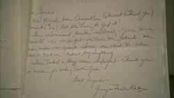 A book with the initials JK opens to a handwritten note. Stock Footage