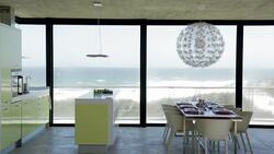 Modern kitchen and dining room with ocean view Stock Footage