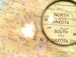 Magnifying glass over North&South Dakota map Stock Footage