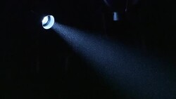 A spotlight dims above stage curtains in a theater. Stock Footage