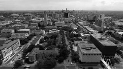 Aerial Over University of Texas Campus UT Clock Tower Austin Texas Skyline black and white close up Stock Footage
