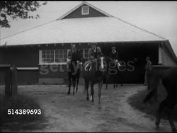 1953: DAWN/DUSK: WS Trees & vegetation in silhouette. MORNING WORKOUT: Greentree Stables exercise riders on thoroughbred racehorses walking out of stable, VS Owner John 'Jock' Hay Whitney (1904-1982) standing grandstand, watching, timing running. Instructional Video