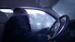 A man freezes in an SUV during a blizzard. Stock Footage