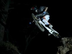 HD Super Slow-Mo: Downhill Biker Jumping Off Rock Stock Footage