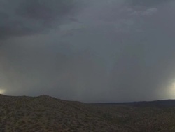 Multiple Forked Cloud to Ground lightning bolt trough very heavy rain shower over mountains. With distant rumble of thunder at end of clip.  Sonoran Desert near Tucson Arizona, USA. Stock Footage