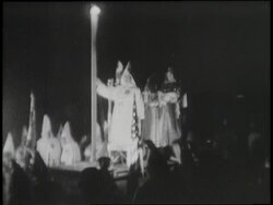 A car carries Confederate and U.S. flags and an illuminated cross at a Ku Klux Klan rally. News Clip