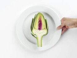 CU Woman hand entering setting down round white plate with an artichoke slice creating a symmetrical design / Omaha, Nebraska, United States Stock Footage