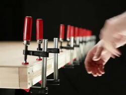 CU, Lockdown, man putting clamps on a construction frame, focus on hands Stock Footage