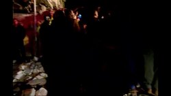 Emergency workers clear rubble, onlookers anxious that building might collapse News Clip