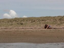 (HD1080i) Beach Yoga: Sitting Up after Forward Stretches Stock Footage
