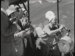 Arturo Toscanini conducts a small informal band outdoors. News Clip