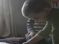 Two boys play game together on table in living room  Stock Footage
