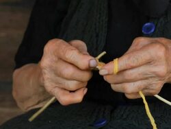 Old wrinkled farmers hands knitting Stock Footage