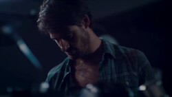 Man in motorcycle workshop looking at his bike Stock Footage