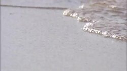 Ocean waves flow onto a coastal beach. Stock Footage