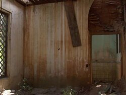A flood-damaged room has stained walls and a floor covered with debris. Stock Footage