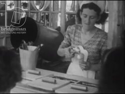 Children buy ice cream and candy floss at a fairground in France. Play games for prizes. Acrobats perform. 1947 Stock Footage