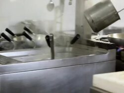 Close up shot of a chef dropping pasta into pan Stock Footage
