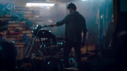 Man in motorcycle workshop building a bike Stock Footage