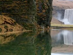 MS TU Shot of Skogafoss Falls which reflected in lagoon / Iceland Stock Footage