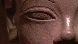 An Egyptian statue features a smooth carved eye and nose. Stock Footage
