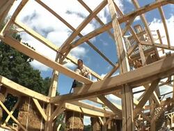 WS CS Carpenter working in rafters while framing an energy efficient post / Grass Lake, Michigan, USA  Stock Footage