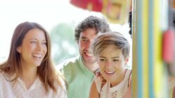Friends playing game at amusement park Stock Footage