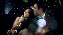 Handsome man kisses girl in backseat of limousine as she smiles for the cameras at awards show Stock Footage