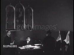 1940: THE VATICAN: INT Office of 'Maestro di Camera Del Papa', w/ chamberlain talking papers from nuns, pilgrims. Man at desk passing out papers to waiting people. People leaving office. Instructional Video