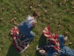 two women dancing with American flags Stock Footage