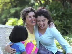 hispanic mother and daughter greeting grandmother with present, Richmond, Virginia, United States Stock Footage