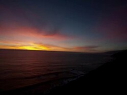WS T/L View of Sunsets over ocean along coast at day to night / Big Sur, California, United States Stock Footage
