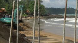 Digger and sunbathers on Khao Lak beach News Clip