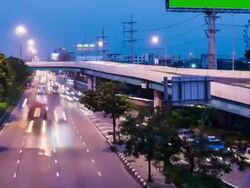 car driving on the road and advertising billboard at dusk Stock Footage
