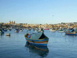MULTI COLOURED FISHING BOATS AND TOWN Stock Footage
