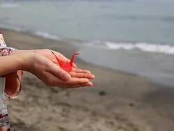 Japanese woman holding red origami Stock Footage