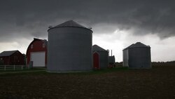 Storm clouds over a diary farm in Wisconsin Stock Footage