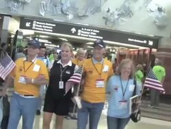 People in airport clap as Honor Flight recipients walk by Stock Footage