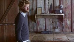 MS Portrait of smiling man leaning against counter in rustic building Stock Footage