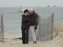 Mature couple walking by the sea Stock Footage