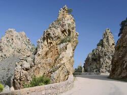 MS Shot of Road through the fantastic rock landscape of the Calanche of Piana, UNESCO World Heritage Site / Gulf of Porto, Corsica, France Stock Footage